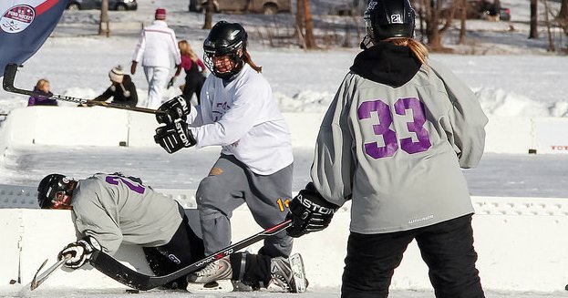 female hockey players body checking opponent.