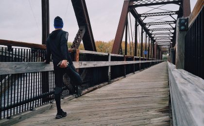 Athlete performing a hockey warm up on a bridge