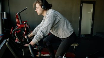 A hockey player working out on a bike.