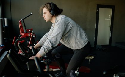 A hockey player working out on a bike.