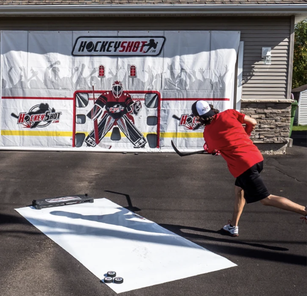 a hockey player taking shots at a shooting tarp.